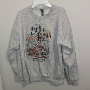 Zach Bryan something in the orange sweater